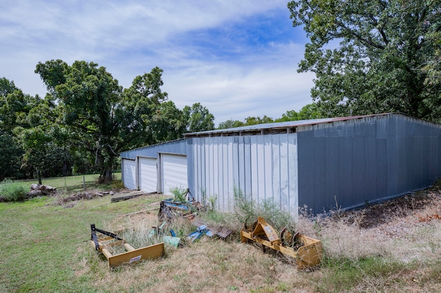 view of outdoor structure with a lawn and a garage