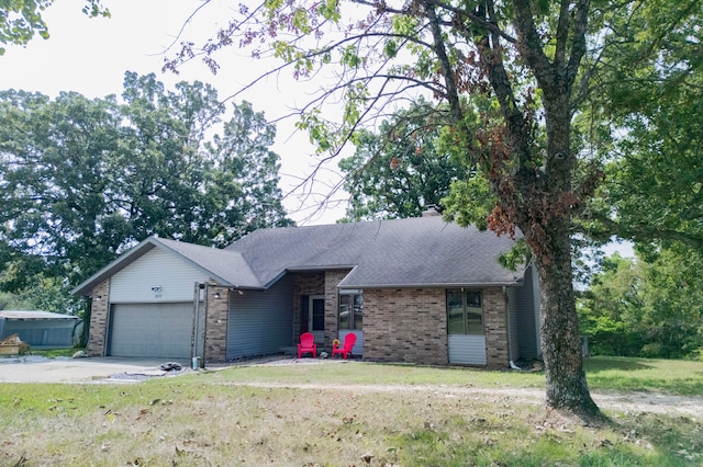 ranch-style home with a garage and a front lawn