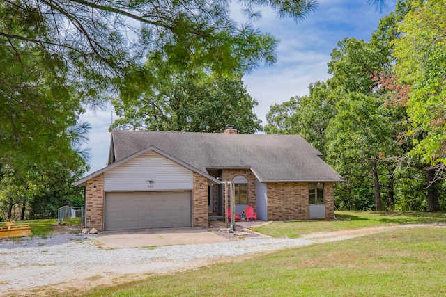 view of front of house with a front yard and a garage