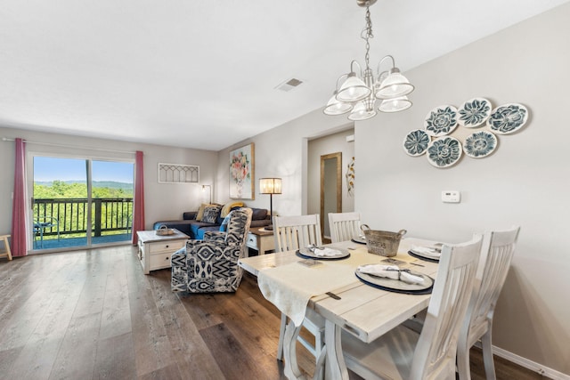 dining space featuring an inviting chandelier and dark hardwood / wood-style flooring