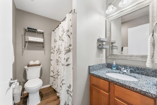 bathroom featuring a shower with curtain, wood-type flooring, vanity, and toilet