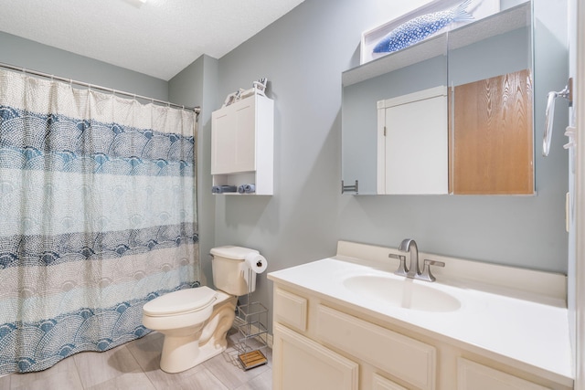 bathroom featuring a textured ceiling, a shower with shower curtain, vanity, and toilet