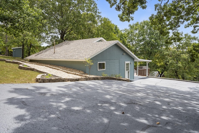 view of property exterior featuring a shed