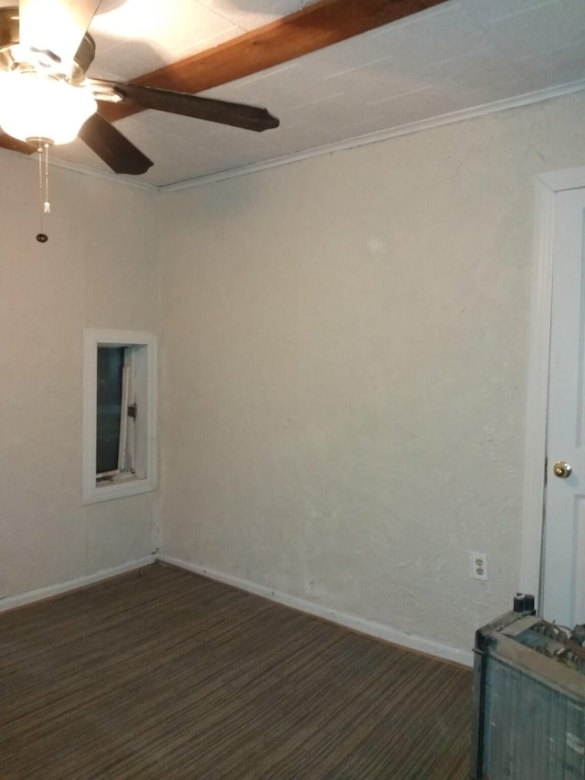 empty room with a ceiling fan, baseboards, ornamental molding, and dark colored carpet