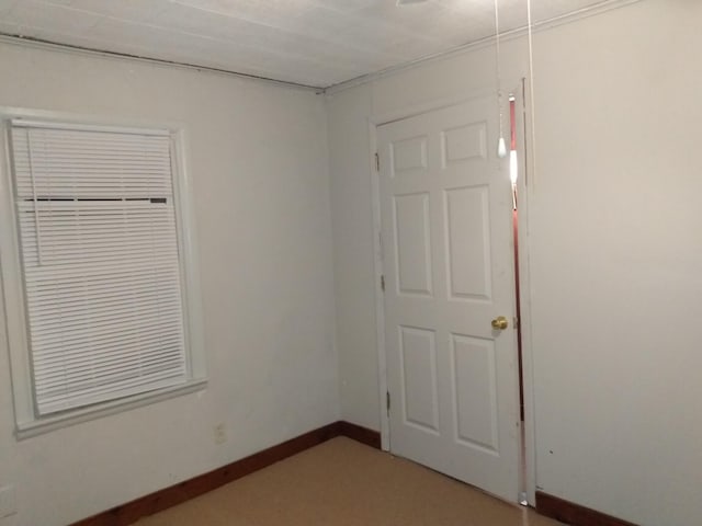 unfurnished room featuring baseboards