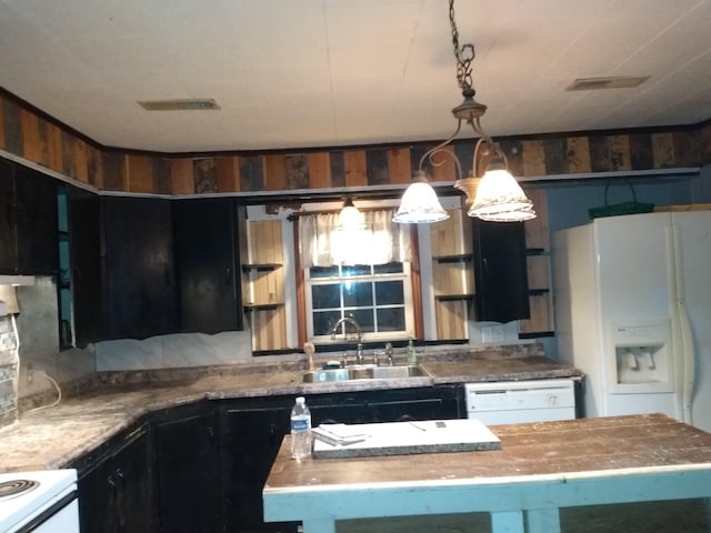 kitchen with pendant lighting, white appliances, butcher block countertops, and sink