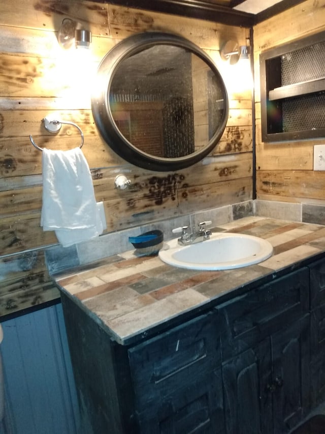 bathroom with wood walls and vanity