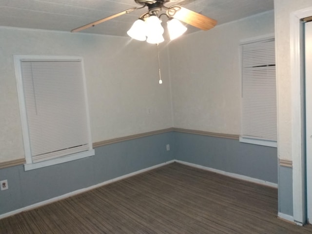 empty room with ornamental molding, ceiling fan, and dark hardwood / wood-style floors