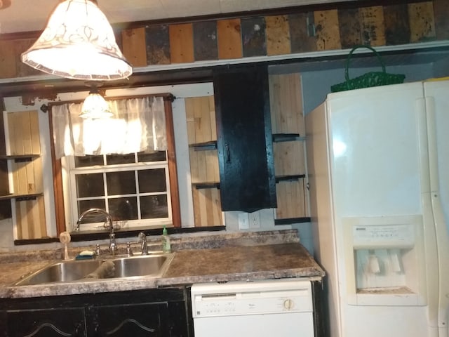 kitchen featuring white appliances and a sink