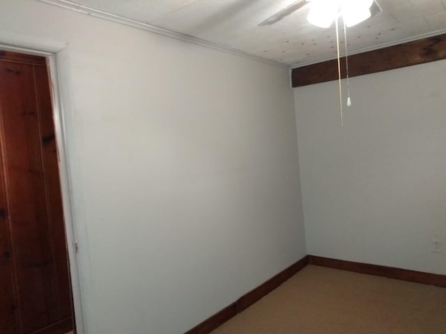 empty room with baseboards and a ceiling fan