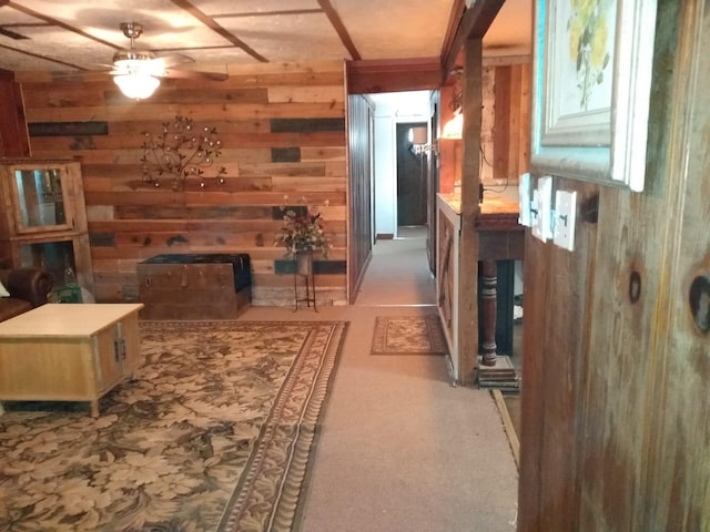corridor featuring carpet floors and wood walls