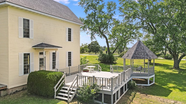 wooden deck featuring a lawn