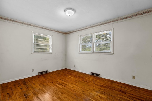 spare room with hardwood / wood-style flooring