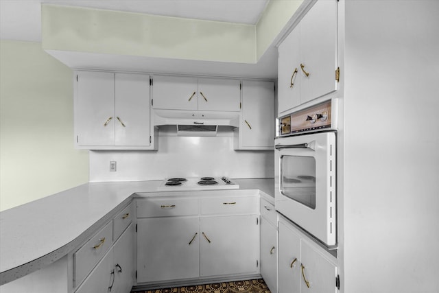 kitchen with white appliances and white cabinetry