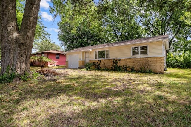 single story home with a front yard and a garage