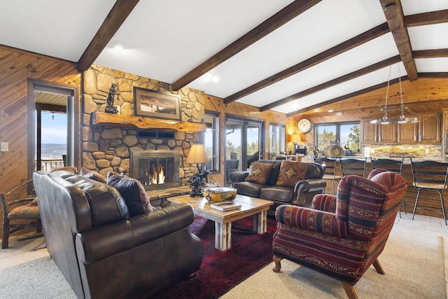91 Blueview Ln, Kimberling City, MO 65686 - living room featuring lofted ceiling with beams, light carpet, a stone fireplace, and wooden walls