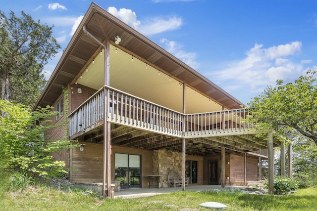 91 Blueview Ln, Kimberling City, MO 65686 - rear view of property featuring stone siding, a patio, and a deck