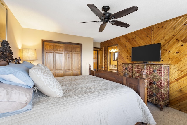 91 Blueview Ln, Kimberling City, MO 65686 - bedroom featuring wood walls, a ceiling fan, carpet flooring, and a closet