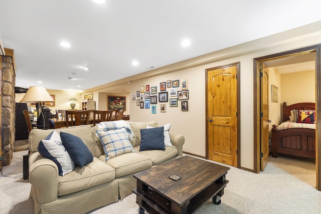 living area featuring recessed lighting, light carpet, and baseboards