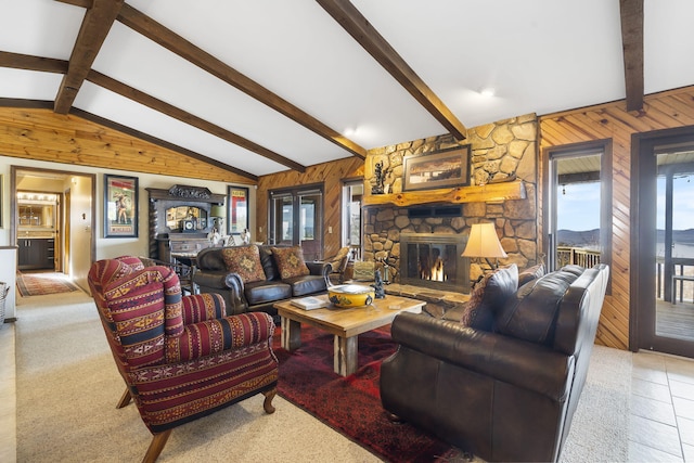 living area featuring vaulted ceiling with beams, a stone fireplace, and wooden walls