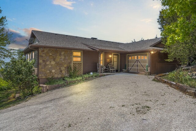 91 Blueview Ln, Kimberling City, MO 65686 - single story home featuring gravel driveway, stone siding, a shingled roof, and a garage