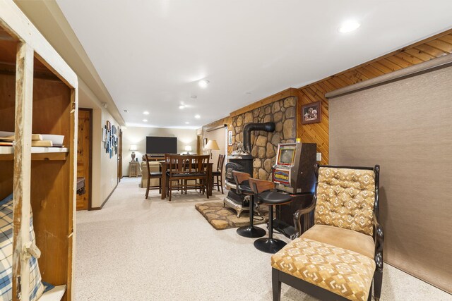 91 Blueview Ln, Kimberling City, MO 65686 - living area with carpet flooring, wood walls, recessed lighting, and a wood stove