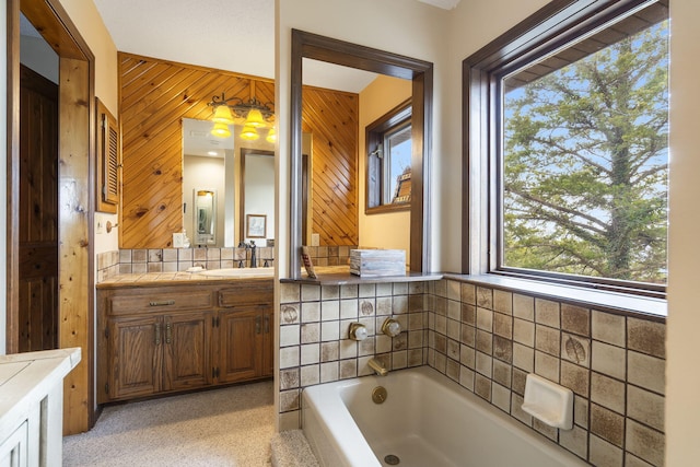 full bathroom with a garden tub, wood walls, and vanity