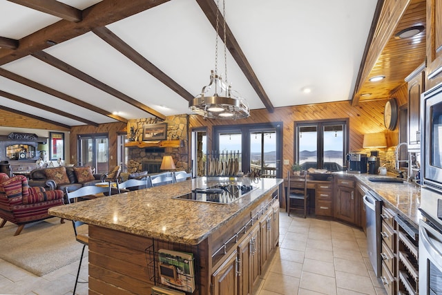 91 Blueview Ln, Kimberling City, MO 65686 - kitchen with french doors, a sink, wooden walls, a breakfast bar, and appliances with stainless steel finishes