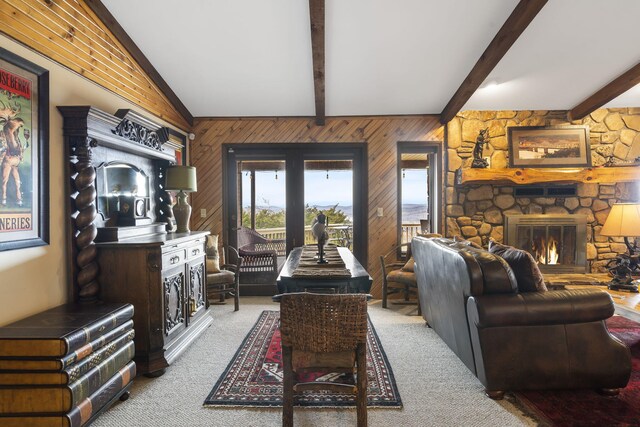 91 Blueview Ln, Kimberling City, MO 65686 - living room featuring wood walls, a stone fireplace, carpet floors, and vaulted ceiling with beams