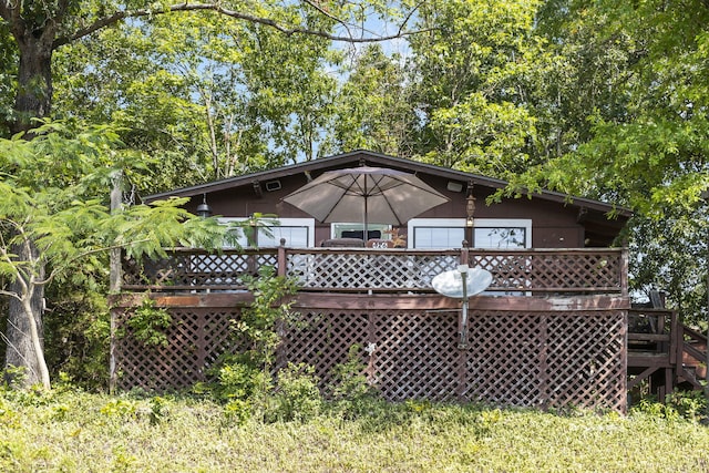 rear view of property with a wooden deck