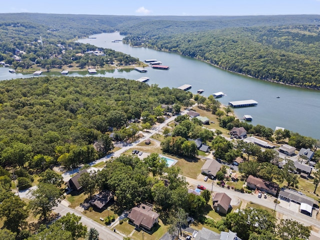 aerial view featuring a water view and a wooded view