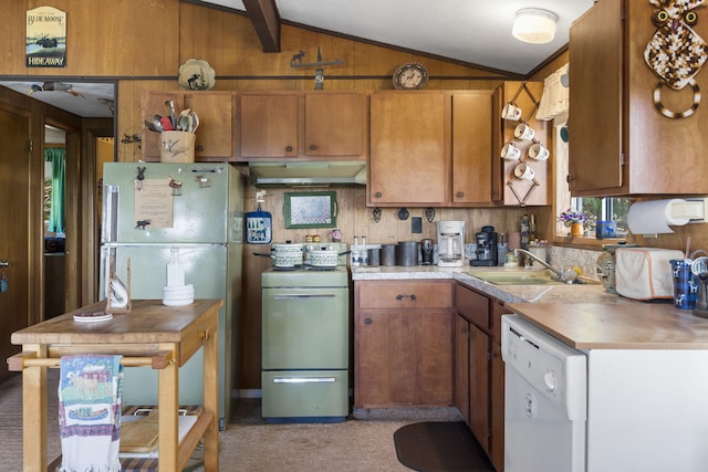 kitchen with a sink, vaulted ceiling with beams, dishwasher, under cabinet range hood, and stove