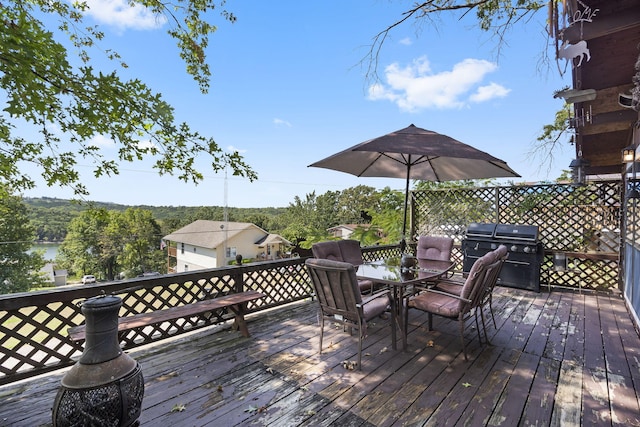 wooden deck featuring outdoor dining area and grilling area
