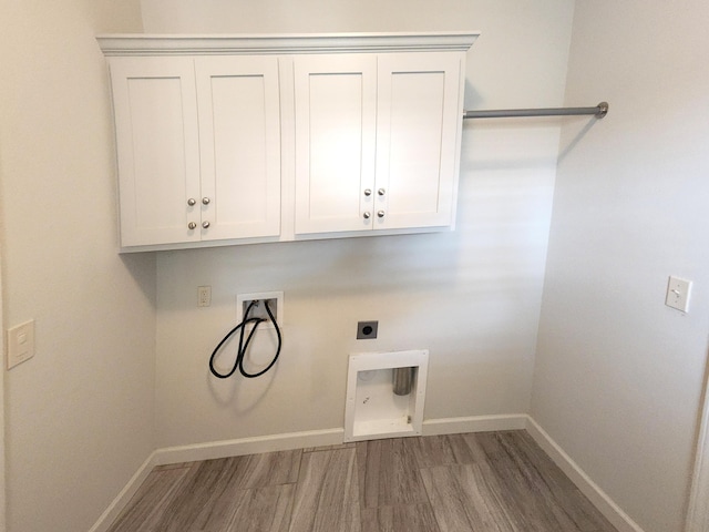 laundry room with hookup for an electric dryer, baseboards, hookup for a washing machine, wood finished floors, and cabinet space