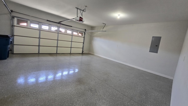 garage featuring baseboards, a garage door opener, and electric panel