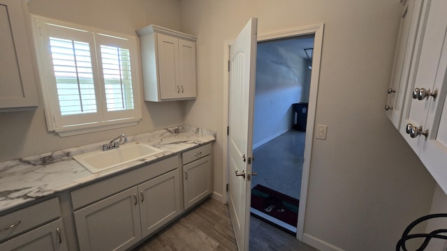 bathroom featuring baseboards and vanity