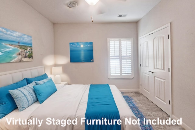 carpeted bedroom with baseboards, visible vents, and a closet