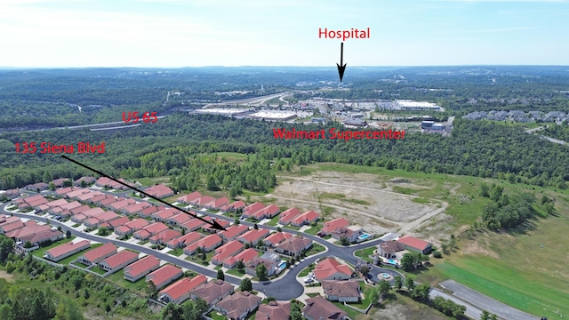 aerial view featuring a forest view and a residential view