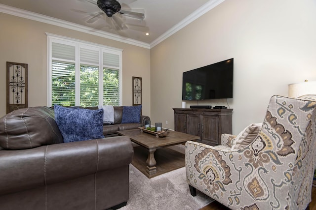 living room with wood finished floors, crown molding, and ceiling fan