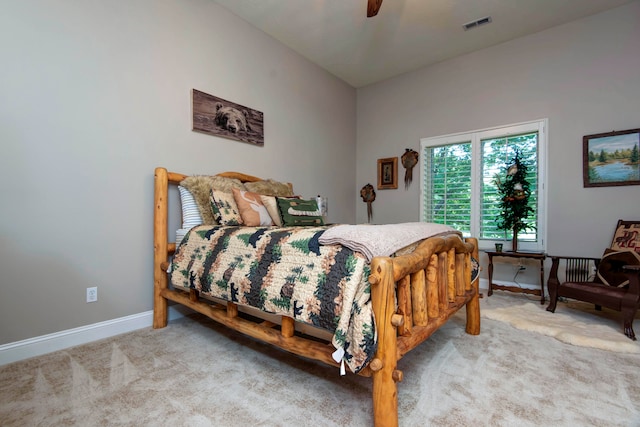 carpeted bedroom with ceiling fan and vaulted ceiling