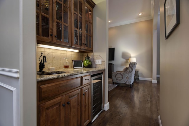 bar with beverage cooler, ornamental molding, a sink, decorative backsplash, and dark wood-style flooring