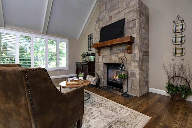 living area with baseboards, dark wood-style flooring, vaulted ceiling with beams, and a fireplace