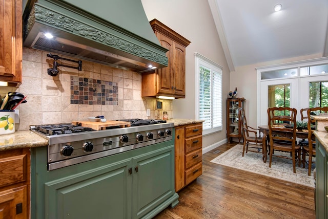 kitchen with lofted ceiling, decorative backsplash, dark wood-type flooring, stainless steel gas stovetop, and custom exhaust hood