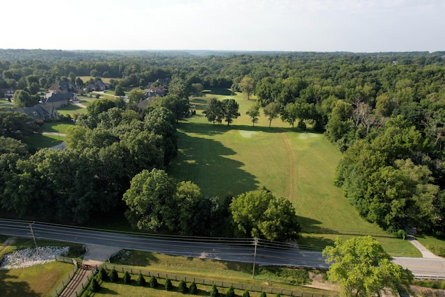 birds eye view of property with a view of trees