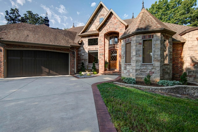 view of front of home with a front lawn and a garage