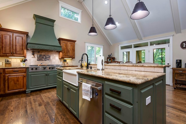 kitchen with dark hardwood / wood-style flooring, green cabinets, a center island with sink, custom exhaust hood, and hanging light fixtures