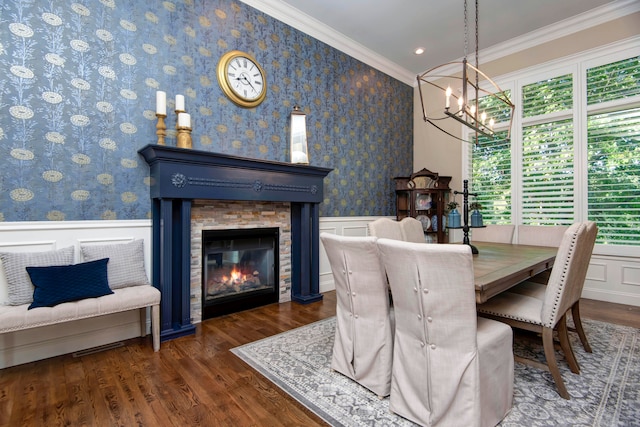 dining space with a healthy amount of sunlight, crown molding, a stone fireplace, and dark hardwood / wood-style floors