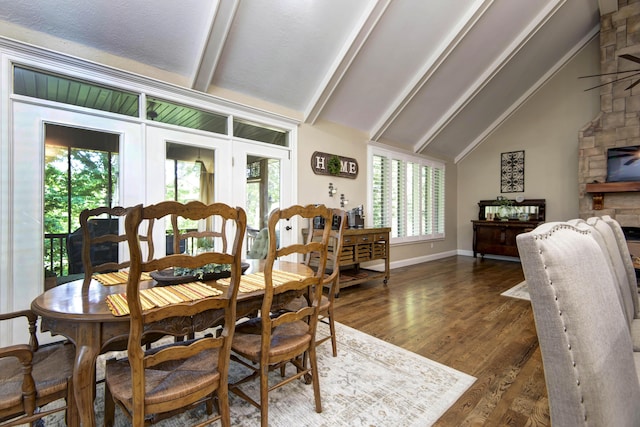 dining space with beamed ceiling, dark wood finished floors, high vaulted ceiling, and baseboards