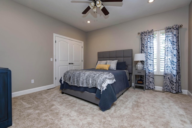 carpeted bedroom featuring a ceiling fan, baseboards, recessed lighting, and a closet