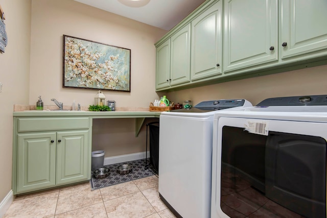 washroom featuring light tile patterned flooring, separate washer and dryer, sink, and cabinets